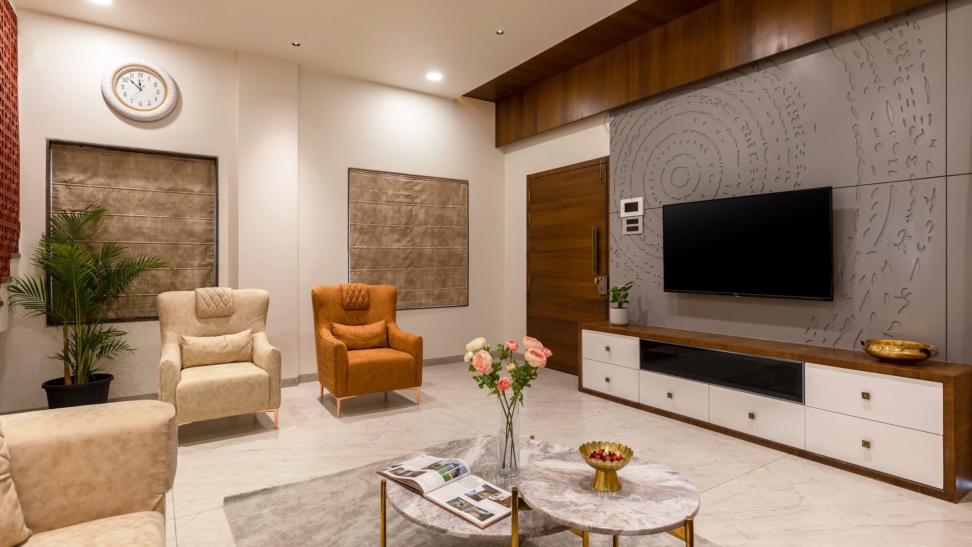 Living room tying a carved stone TV wall, timber ceiling band, framed textile panels and coordinated seating together — Mr. Vikram Kauthkar, Shirur