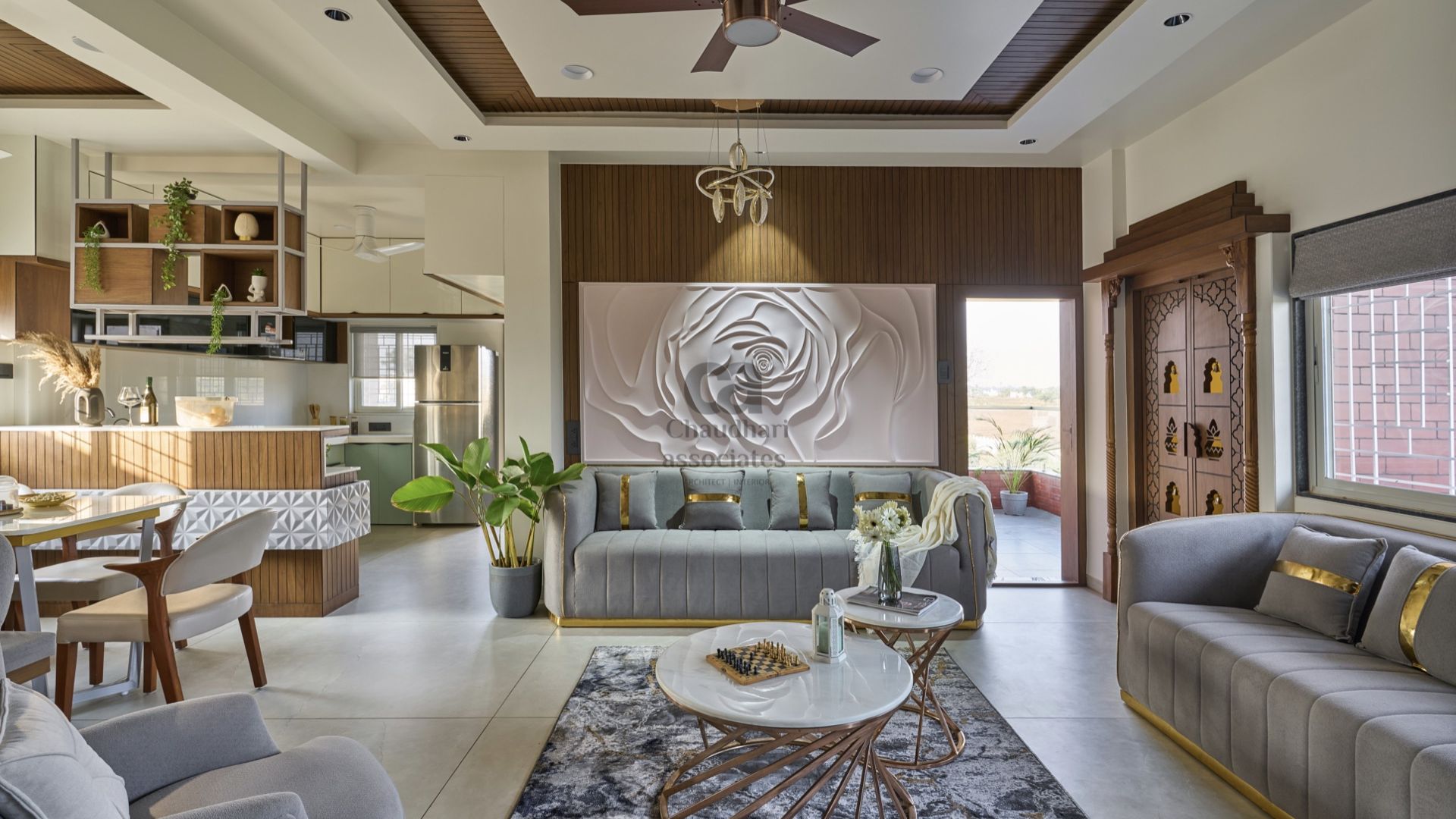 Living room with a sculpted rose relief wall opening onto dining and kitchen — Mr. Sagar Bhagat residence, Shikrapur